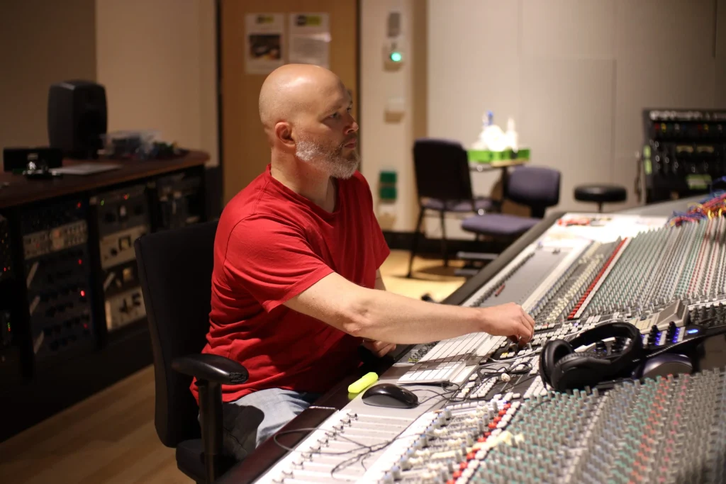 Daniel Jason Booth mixing a song on a large-format analog console